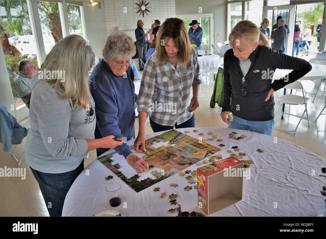 Women From Real Family At Gathering Doing Crossword Puzzle Mother At 90 And 2 Daughters And In Laws At Barbecue Having Fun Together Stock Photo Alamy Women From Real Family At Gathering Doing Crossword Puzzle Mother At 90 And 2 Daughters And In Laws At Barbecue Having Fun Together Stock Photo Alamy
